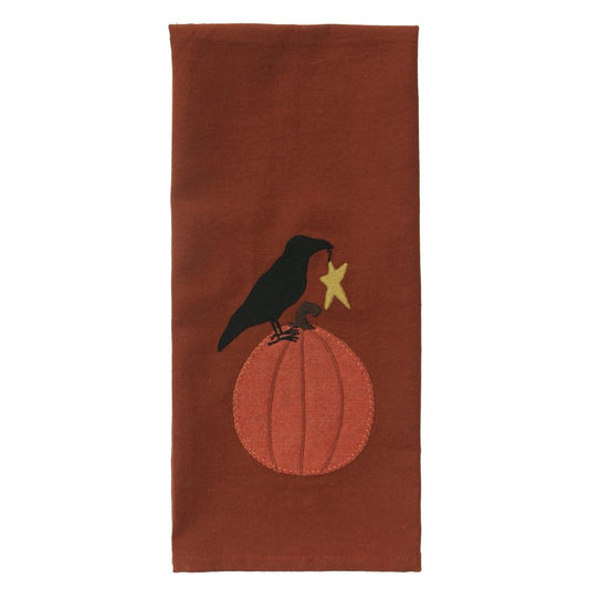 Brown fabric with a black crow on a pumpkin and yellow star design