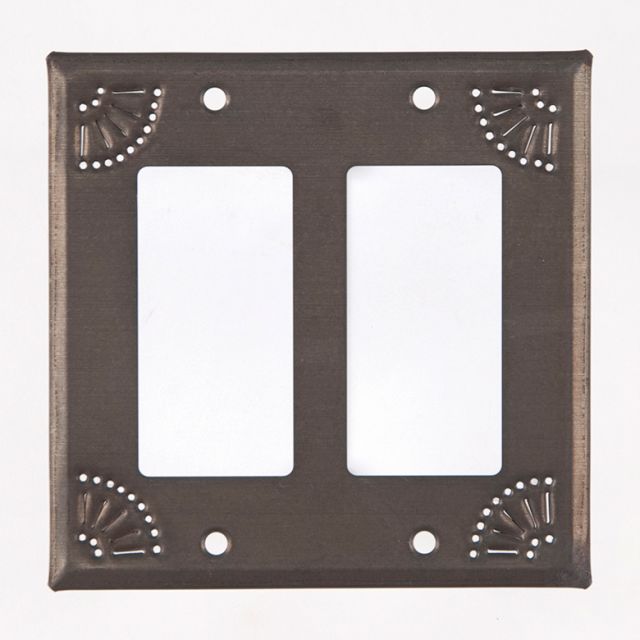 A black tin wall plate with a matte finish and decorative chisel work around the edges.
