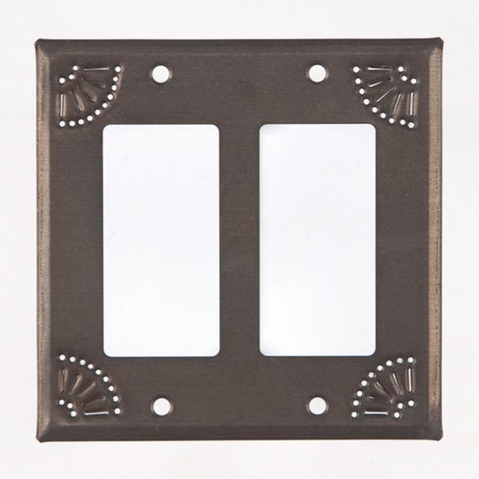 A black tin wall plate with a matte finish and decorative chisel work around the edges.
