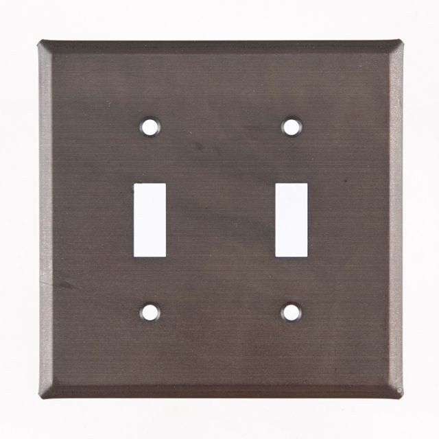 A kettle black double switch cover for wall plates, made of metal with a matte lacquer protective coating.
