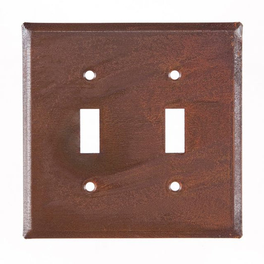 Double switch cover unpierced in rusty tin finish on white background.