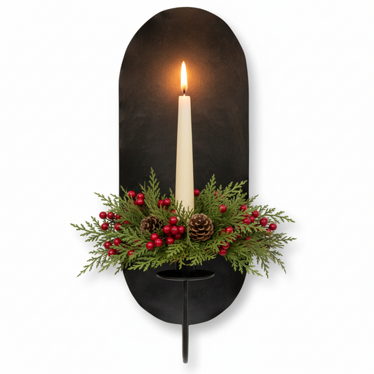 Decorative wall sconce with a candle and festive greenery on a white background