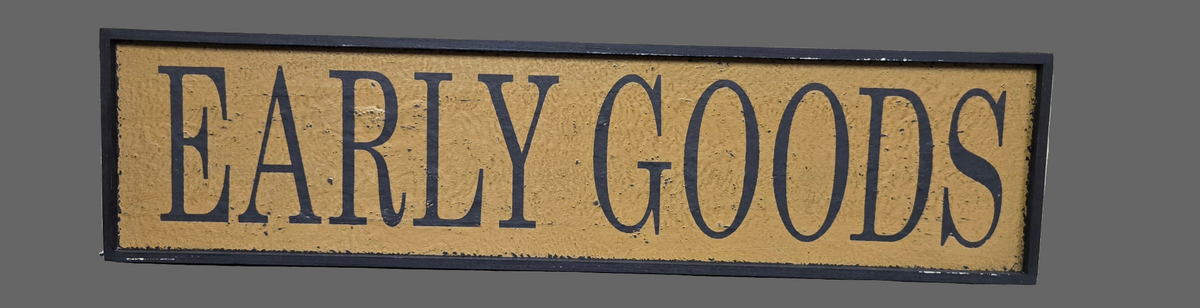 Decorative sign with 'EARLY GOODS' text on a plain background