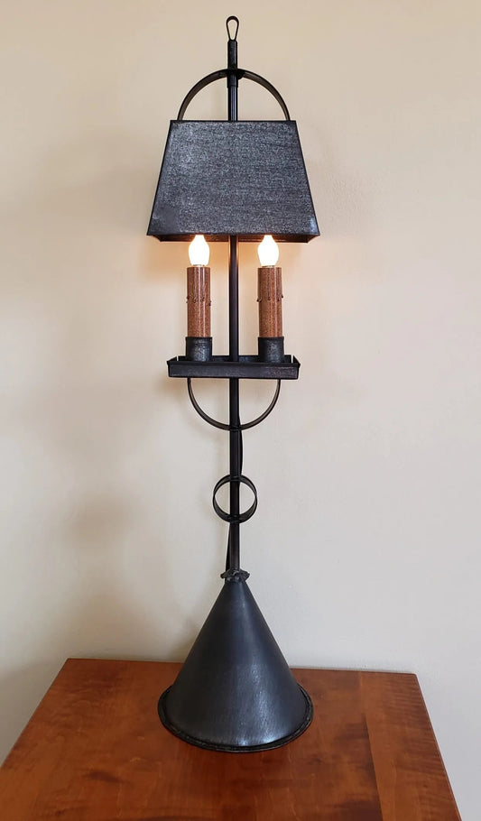 Decorative lamp with a black shade on a wooden surface.