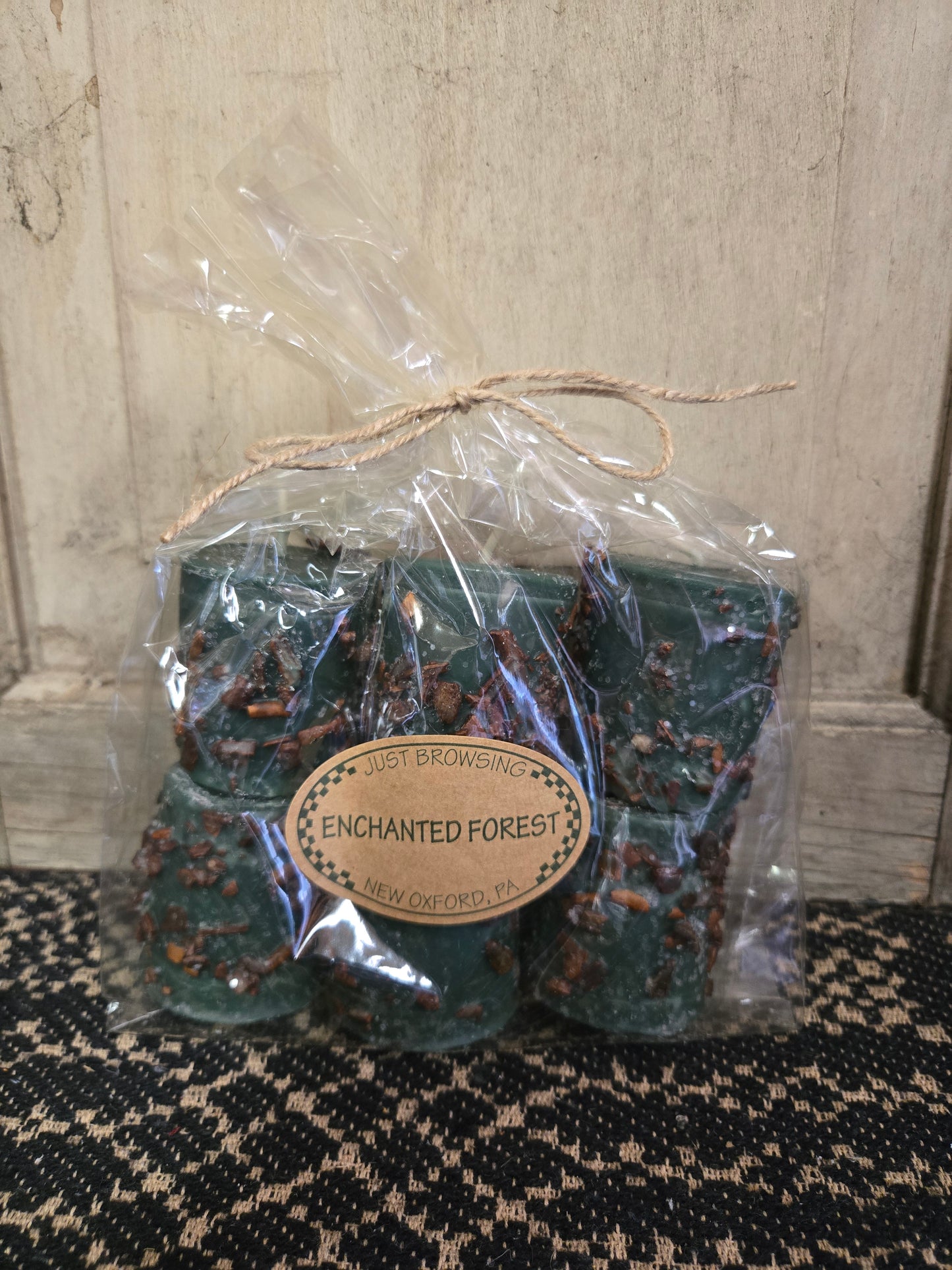 A pack of Enchanted Forest scented votive candles, hand poured and hand rolled, with a warm aroma of baked apples with cinnamon and spices.