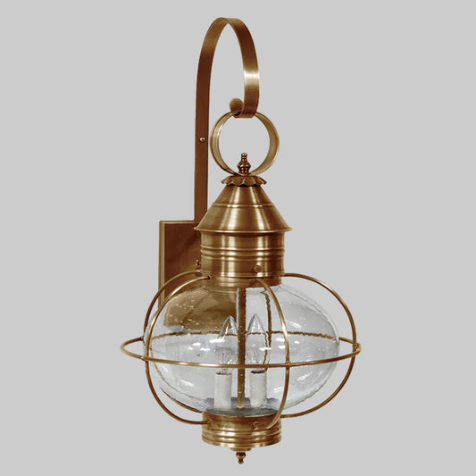 Brass outdoor wall light fixture with clear glass shade on a white background
