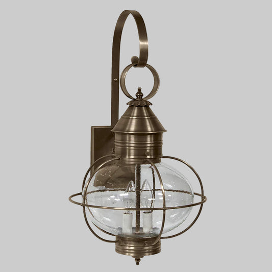 Bronze outdoor wall light fixture with clear glass shade on a white background