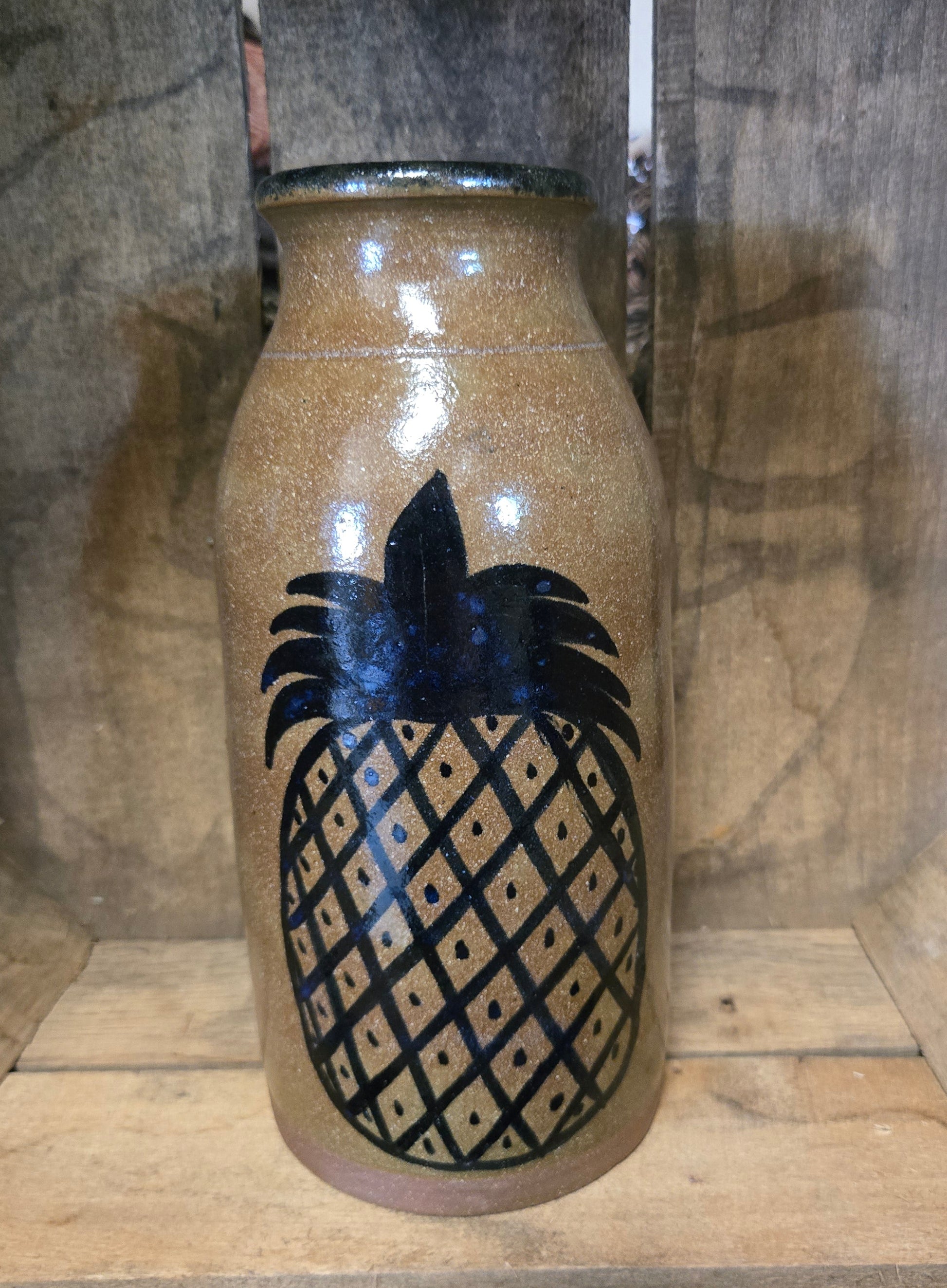 Pineapple design on on stoneware crock.