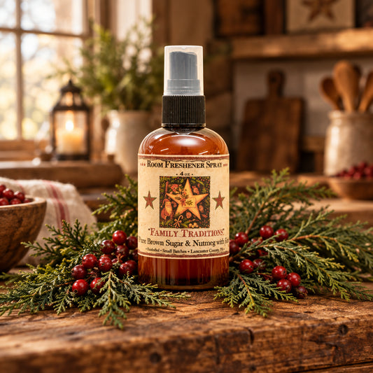 Room freshener spray bottle with a festive label against a blurred Christmas tree background