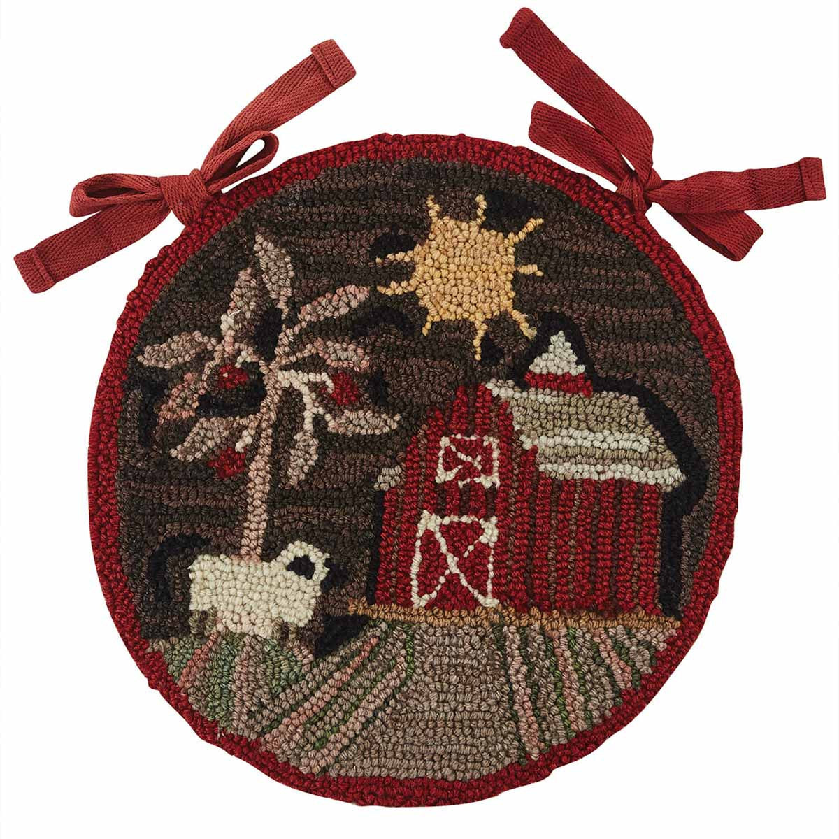 A round, hooked chair pad with a barn and sheep design, featuring a brown base with a red border and sun motif in the center.