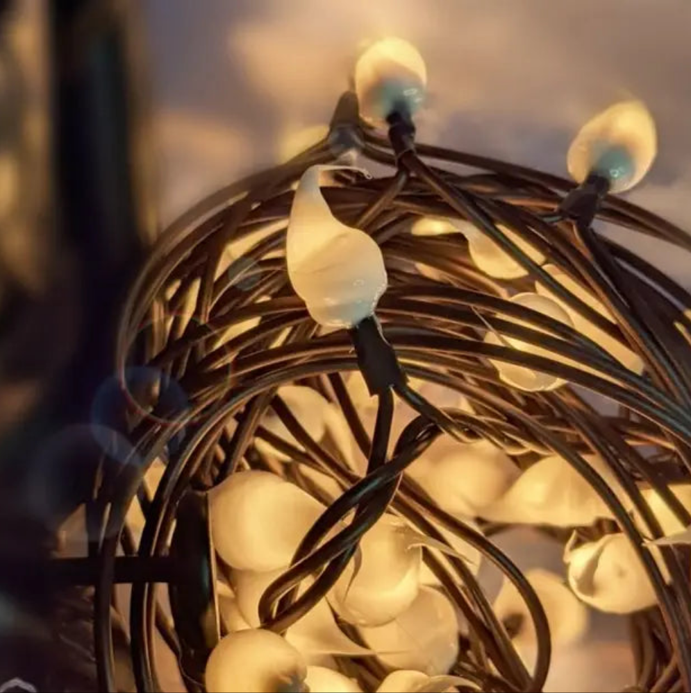 A close-up image of a strand of silicone string lights with visible LED lights glowing in the dark.