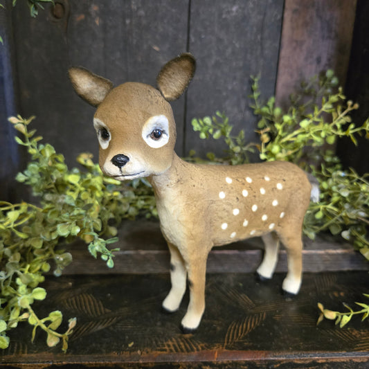 Faux deer head with white spots on a dark background