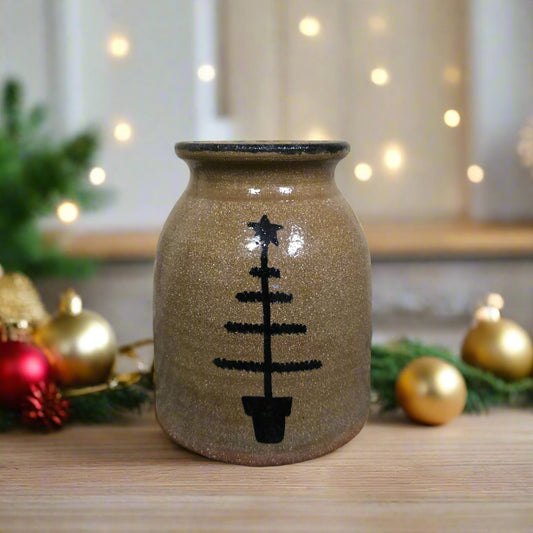 Ceramic vase with black pattern on a textured surface