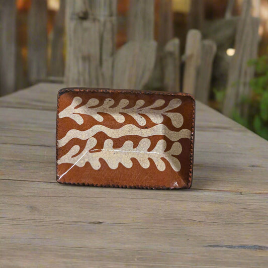 Small rectangular red ware plate with feathered glazing