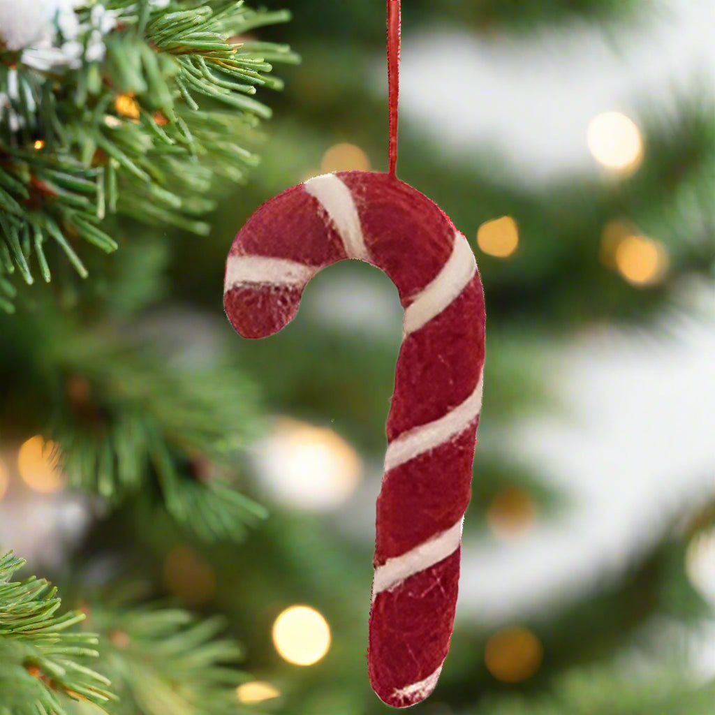Felted candy cane ornament on white background
