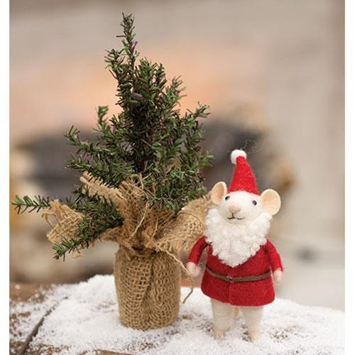 Small mouse figure in a Santa outfit next to a miniature Christmas tree wrapped in burlap.
