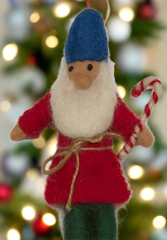 Handmade felted wool gnome ornament with a blue hat, red coat, white beard, and holding a candy cane.