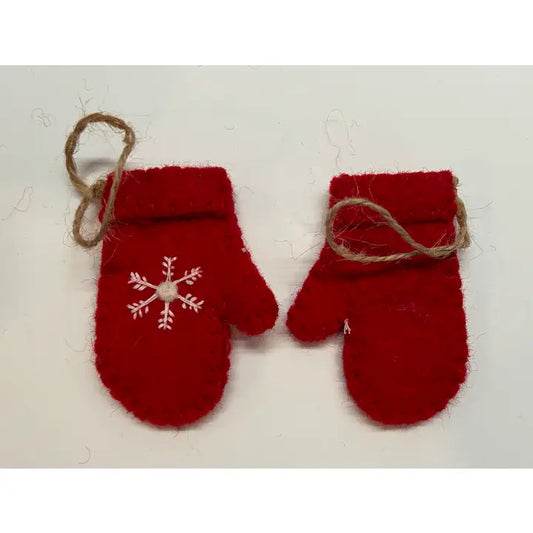 A pair of red felted wool mittens with a white embroidered snowflake design on the front and a hanging loop, displayed against a white background.