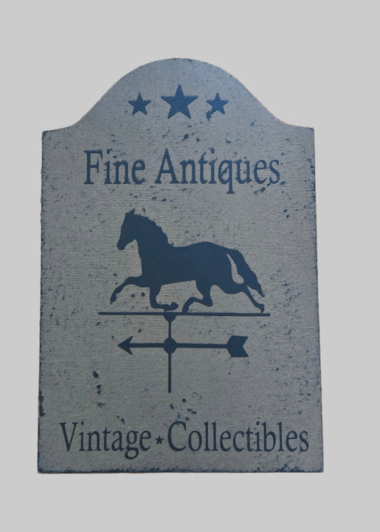 Decorative sign with horse silhouette and text 'Fine Antiques Vintage Collectibles' on a gray background