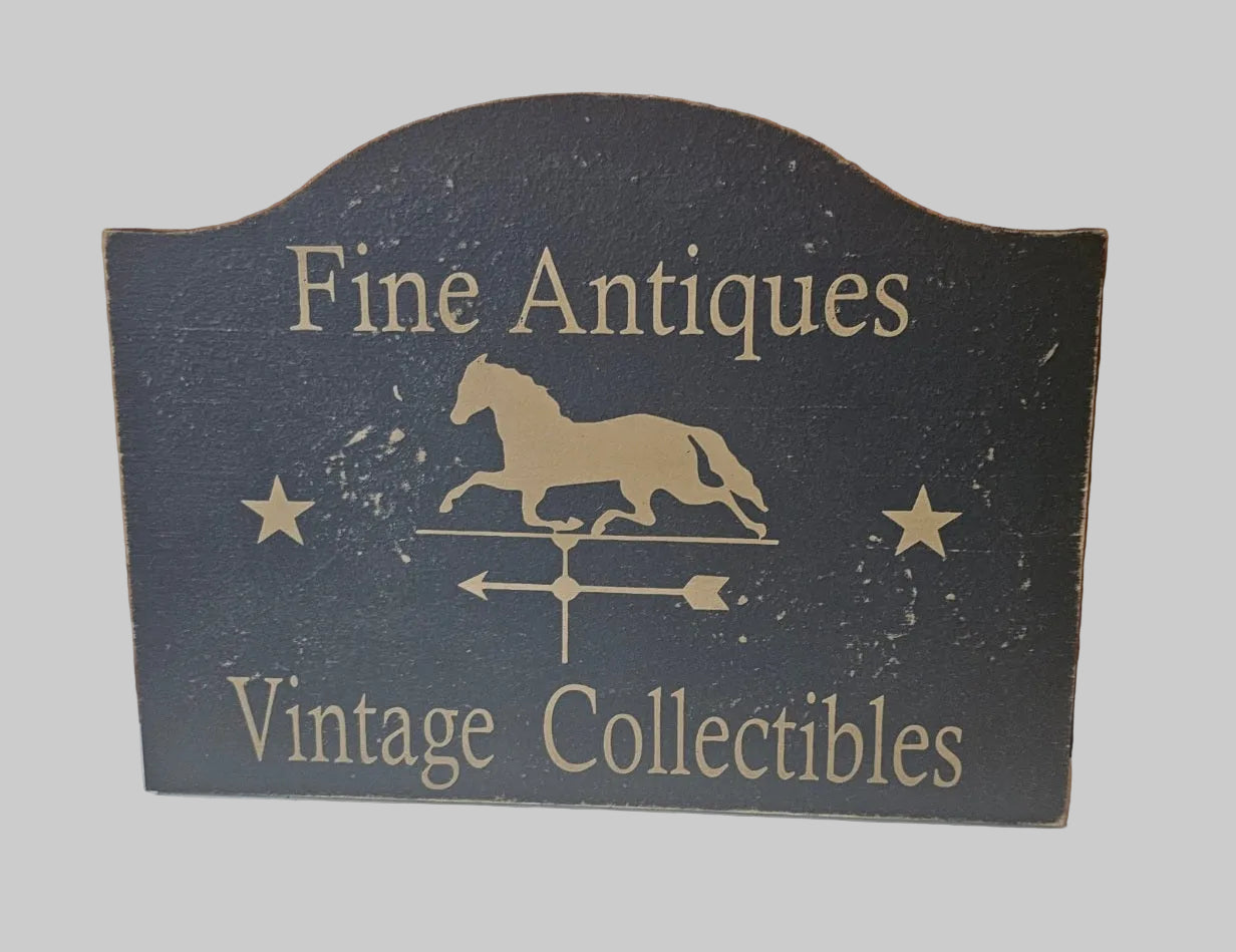 Decorative sign with 'Fine Antiques' and 'Vintage Collectibles' text on a dark background.
