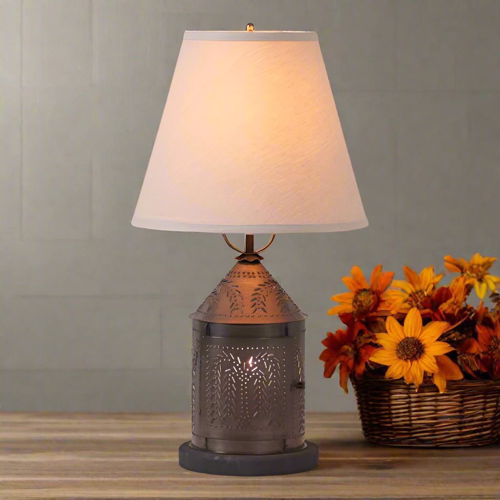 Decorative table lamp with a textured bronze base and beige lampshade on a white background
