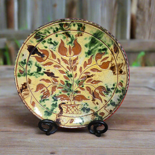 Redware plate with tulip motif and brown, yellow and green glazing