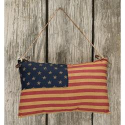 Vintage-style American flag hanging on a wooden wall