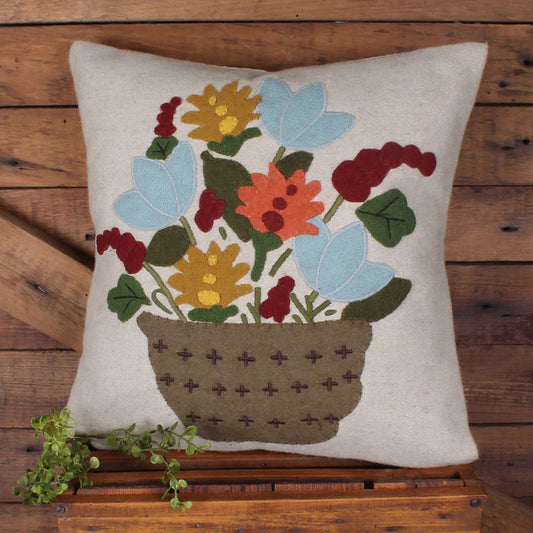 Decorative pillow with floral design on a wooden background