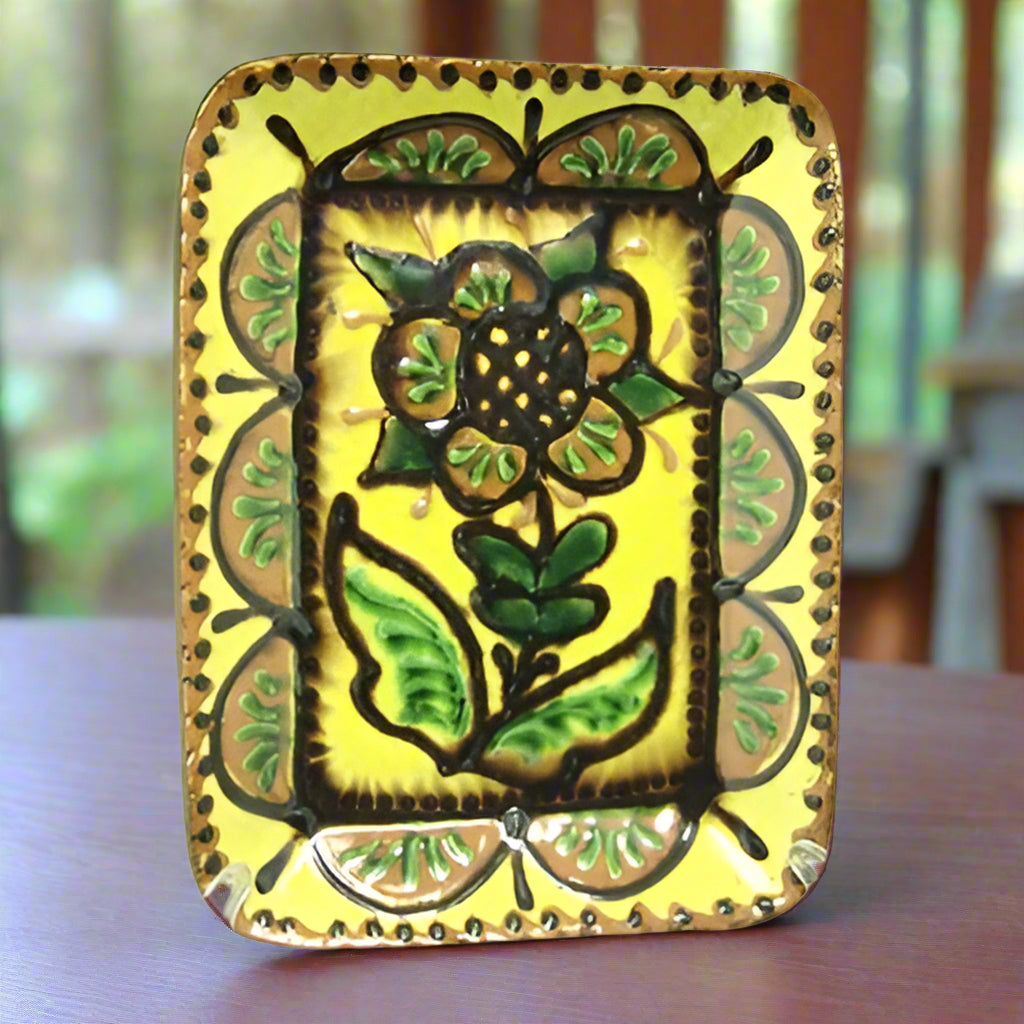 Redware plate in rectangular shape with floral motive glazed in yellow, brown and green