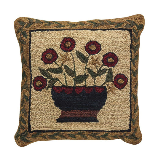 A square-shaped throw pillow with a floral design featuring a basket of red and yellow flowers on a green background, with a border of green leaves.
