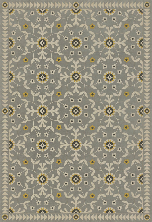 A vinyl floor cloth with a gray background and a floral pattern featuring yellow and white elements.