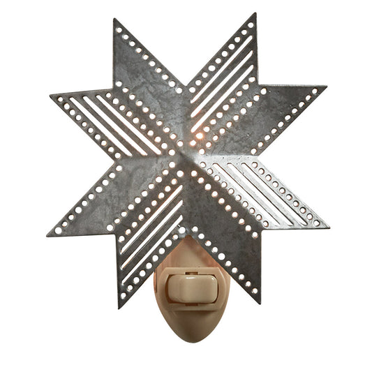 A metal night light in the shape of a folk star with a pull chain switch, mounted on a wall.