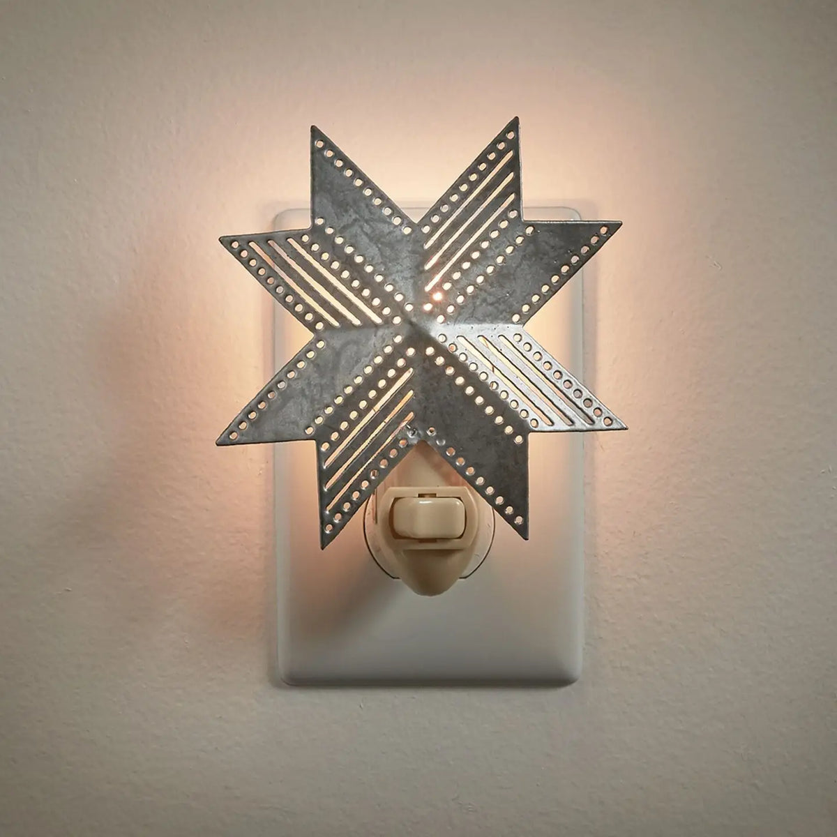 Decorative star-shaped night light on a wall