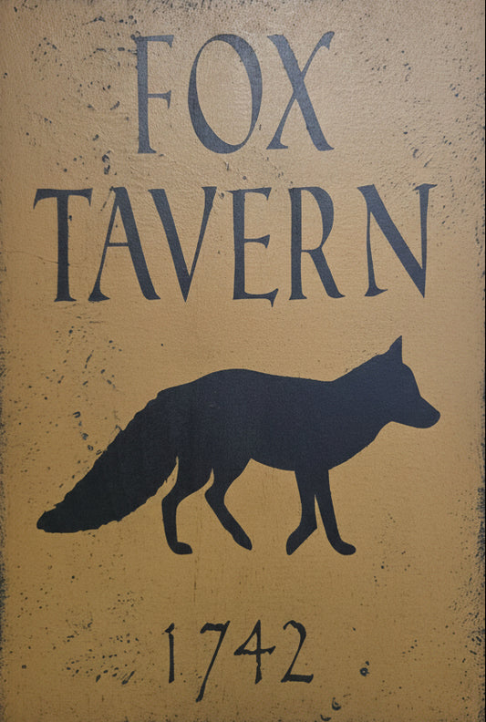 Sign for Fox Tavern with a fox silhouette and year 1742 on a wooden background