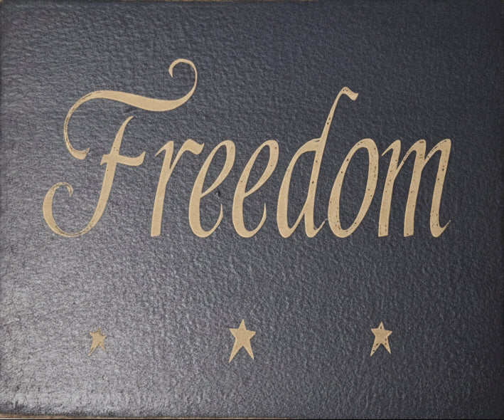 Black book with 'Freedom' written in gold on a light gray background
