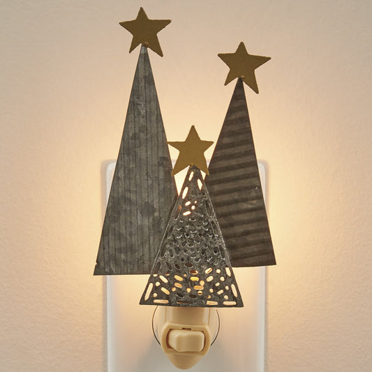 A wall-mounted night light featuring silhouettes of trees with star cut-outs in a warm gray color emitting a soft glow.