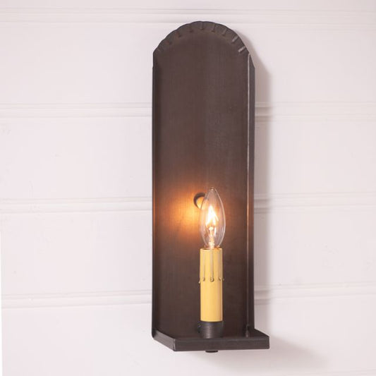 Wall-mounted light fixture with a candle-style bulb on a white background