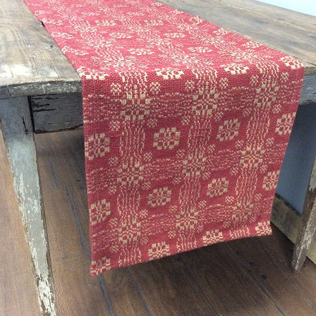 Red patterned table runner on a wooden table