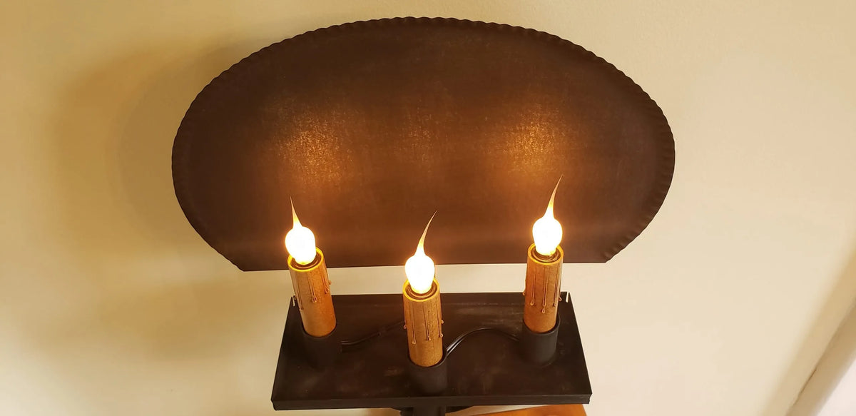 Top view of candle pan on a tin table light.