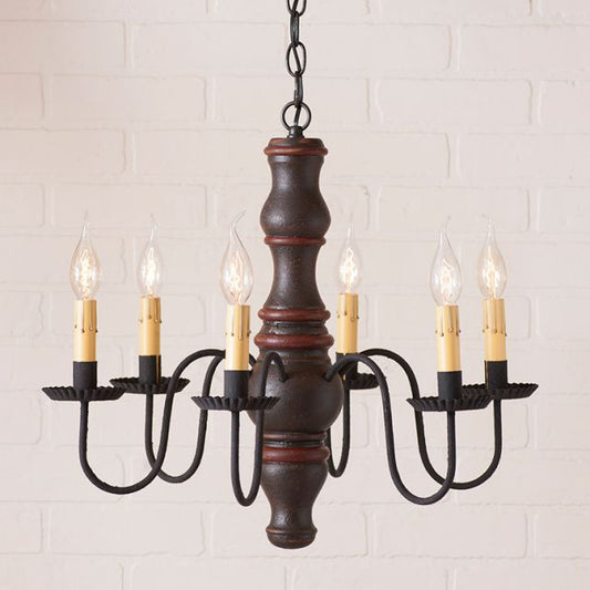 Vintage-style chandelier with six candles on a white brick wall background