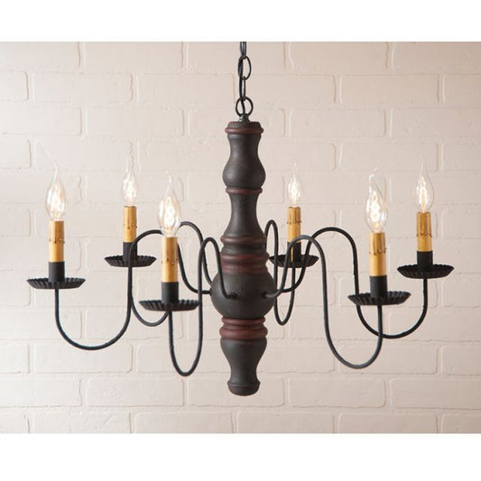 Wooden chandelier with six candle-style lights on a white brick wall background