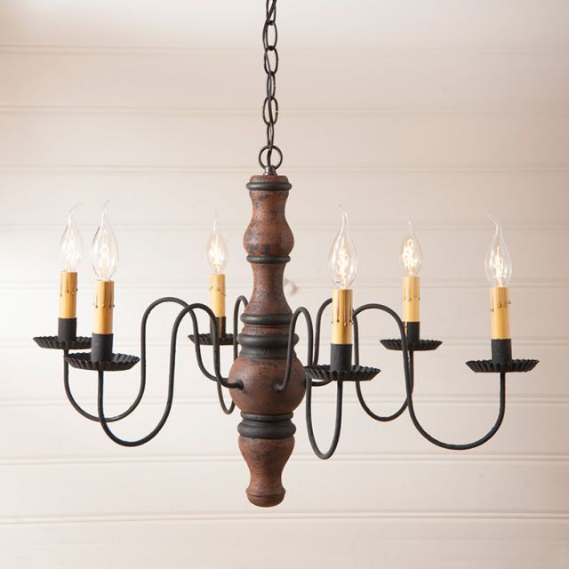 Wooden chandelier with five candle-style lights on a plain background