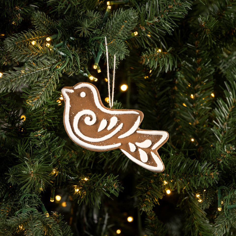 Decorative bird ornament on a Christmas tree with lights