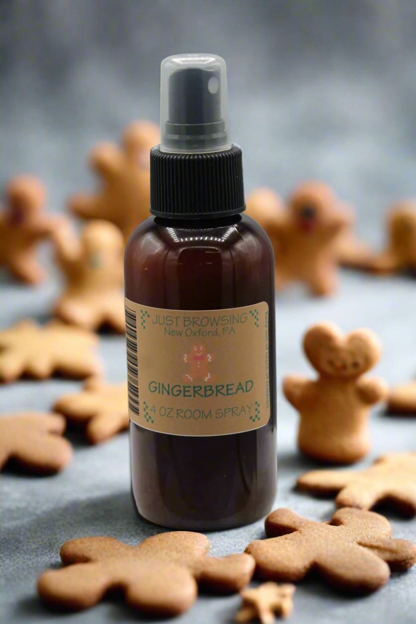 Gingerbread-themed room spray bottle with gingerbread cookies on a dark surface