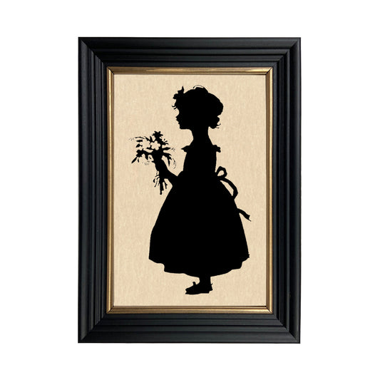 A paper cut silhouette of a girl with a bouquet of flowers, framed in a black solid ash wood frame with gold trim.