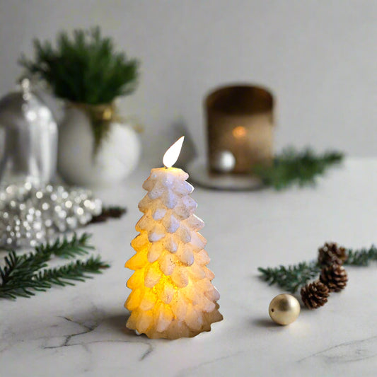 A LED tree-shaped candle with a burnt ivory color, illuminated to mimic a real candle flame, placed on a black surface with a wooden background.
