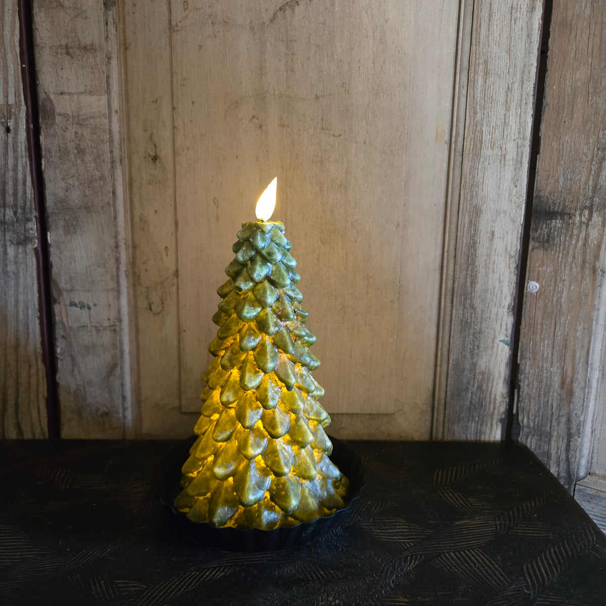 Tree candle on black stand.