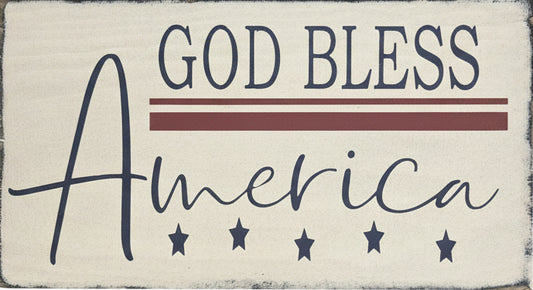 Wooden sign with 'God Bless America' text on a wooden surface