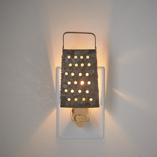 A grater night light with a metal grating and a light source mounted on a wall.