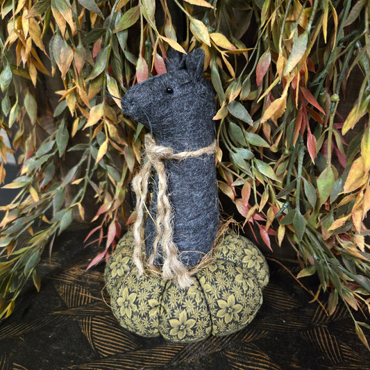 Decorative item with a textured surface and floral pattern on a leafy background